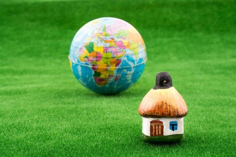 Hut near a globe on green grass