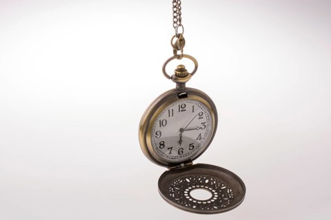 Retro style pocket watch on white background