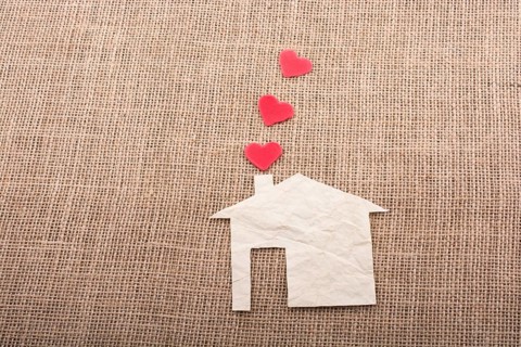 Heart shape coming out of chimney of paper house