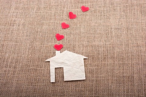 Heart shape coming out of chimney of paper house