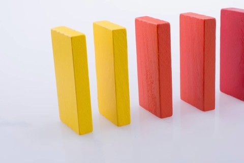 Colorful Domino Blocks in a line on a white background