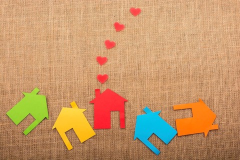 Heart shape coming out of chimney of paper house