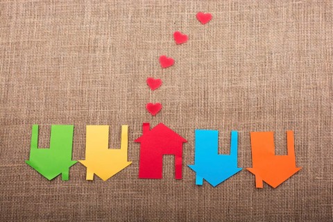 Heart shape coming out of chimney of paper house