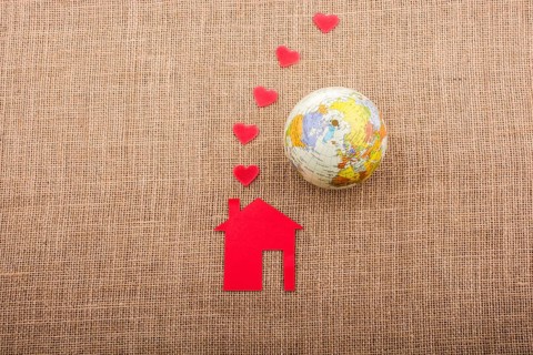 Heart shape coming out of chimney of paper house