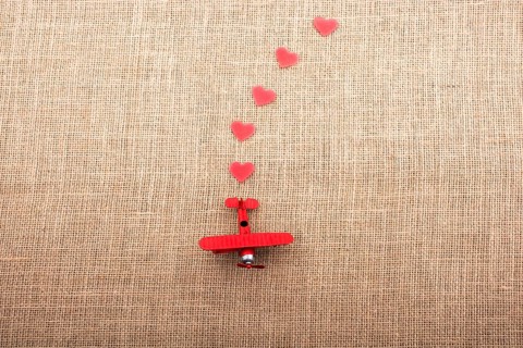 Heart shaped objects behind an red model airplane