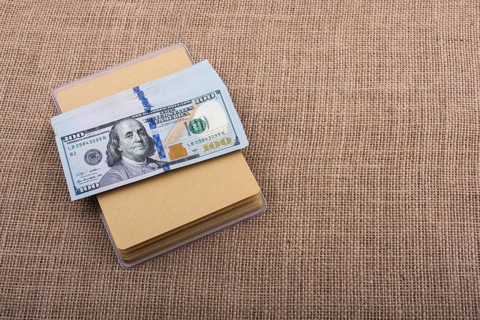 Banknote bundle of US dollar placed on a linen canvas