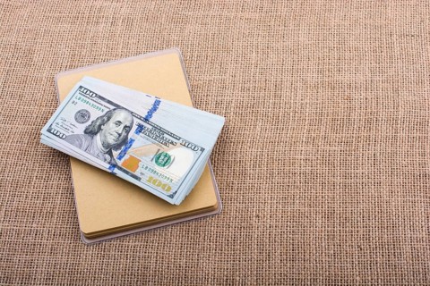 Banknote bundle of US dollar placed on a linen canvas