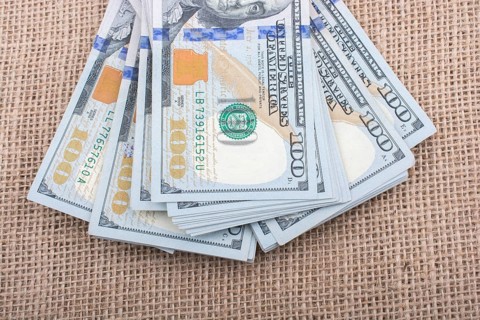 Banknote bundle of US dollar placed on a linen canvas