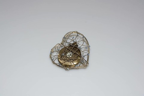 Mechanical retro styled pocket watch in a heart cage