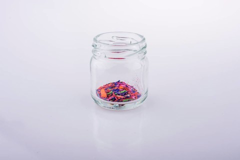 Little perfume glass bottle on a white background