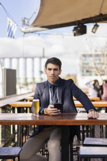 Man thinking something after checking his smartphone
