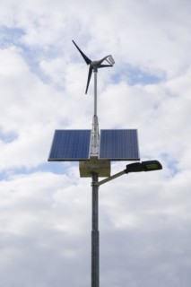 Street lamp with solar panels and small wind turbine