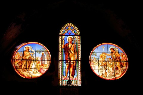 Three stained glass windows with John the Baptist of Saint-Dame-du-Bon-Remède Church