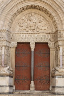 Portal with tympanum of the Romanesque St-Trophime Cathedral