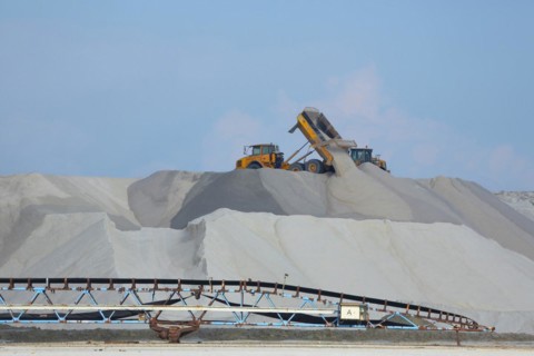 Dump truck unloading salt at a salt mine for salt extraction
