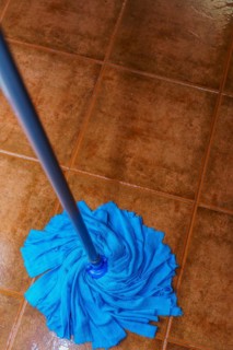 Top view of a blue mop mopping the floor