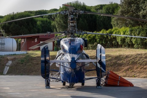 Firefighting helicopter parked at the heliport waiting for a forest fire warning