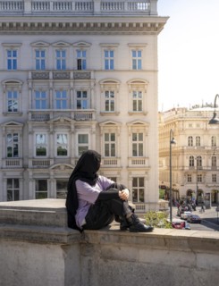 Tourist sitting on a balustrade