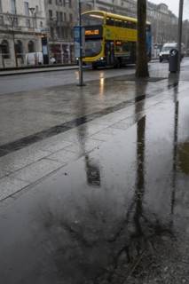 A Dublin bus passes by on a rainy day in January in the Irish capital city of Dublin