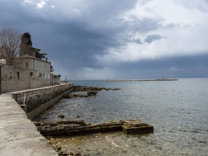 Coast with lighthouse in front of Porec