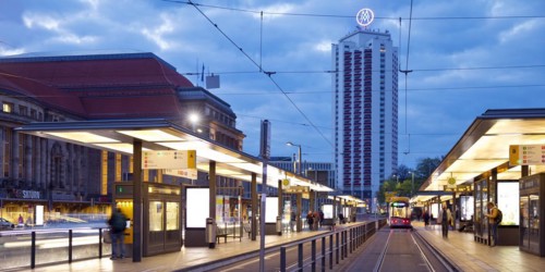 Early morning tram stop at the main station with winter garden high-rise