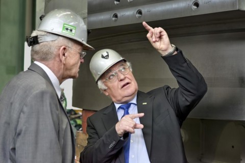 Minister President Winfried Kretschmann with Martin Herrenknecht - both wearing safety helmets - during a visit to Herrenknecht AG