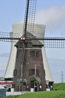 The windmill Scheldedijkmolen and cooling towers of the Doel Nuclear Power Station along the river Scheldt at Kieldrecht