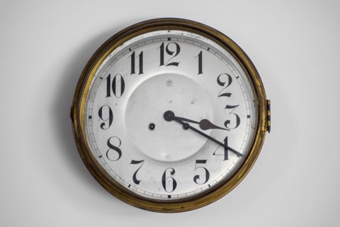 Vintage circular wall clock from the early twentieth century made by Junghans Uhren GmbH