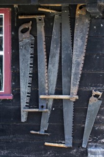 Collection of antique two-man saws and vintage crosscut saws