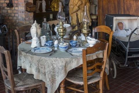 Old dining room with antique furniture and vintage dinner set