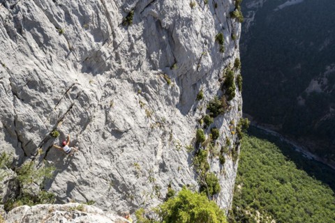 Rock climber climbing rock face in the Gorges du Verdon