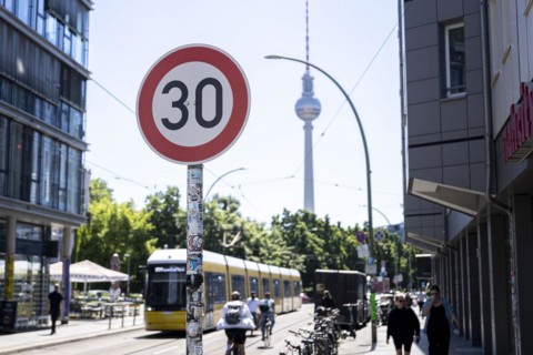 A speed 30 sign stands in the foreground of the TV Tower in Berlin
