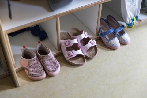Shoes on a coat rack in a kindergarten