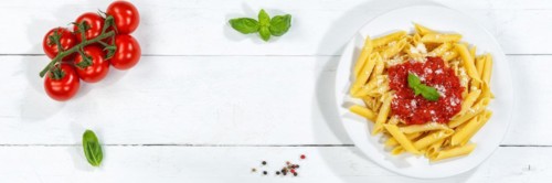 Penne Rigatoni Rigate Italian pasta in tomato sauce eat lunch dish on plate from above Panorama copy space Copyspace in Stuttgart