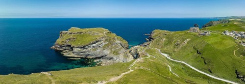 Aerial panorama of the rugged coastline on the Celtic Sea with the Tintagel Peninsula and the ruins of Tintagel Castle