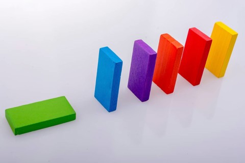 Colorful Domino Blocks in a line on a white background