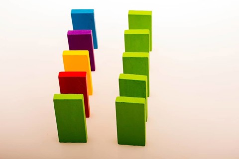 Colorful Domino Blocks in a line on a white background
