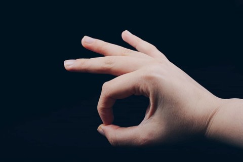 Hand gesturing sign ok okay agree on black background