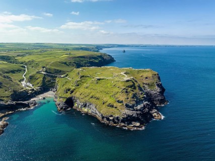 Aerial view of the rugged coastline on the Celtic Sea with the Tintagel Peninsula and the ruins of Tintagel Castle