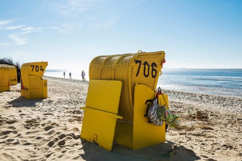 Yellow beach chairs and mudflats