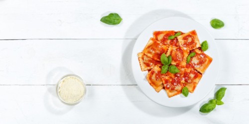 Ravioli Italian pasta eat lunch dish with plate in tomato sauce from above on wooden board copy space Copyspace in Stuttgart