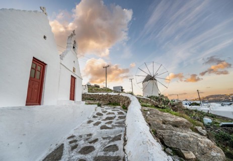 White Cycladic Greek Orthodox Twin Churches of Agios Antonios and Agios Nikolaos with Bonis Windmill at Sunrise