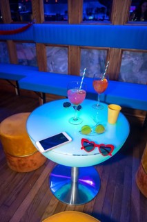 Glasses of glasses on a reserved table at a night party in a disco on vacation