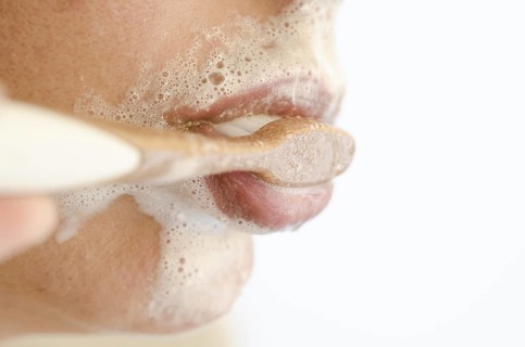 Woman Brushing the Teeth with a Toothbrush