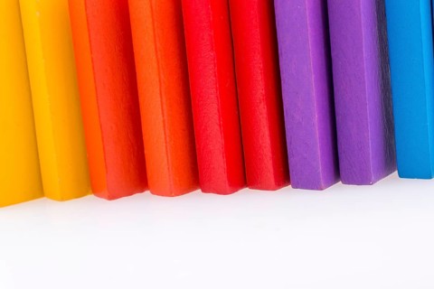 Colorful Domino Blocks in a line on a white background