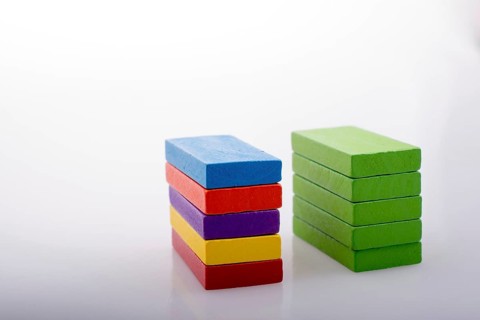 Colorful Domino Blocks in a line on a white background