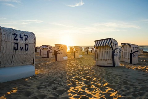 White beach chairs and mudflats