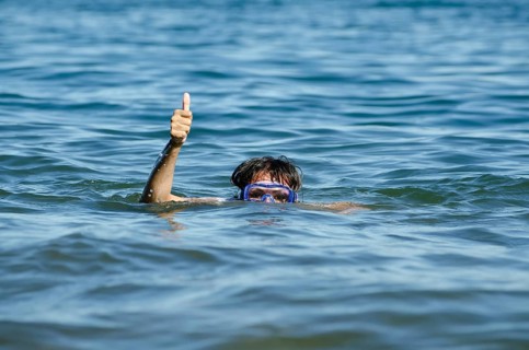 Woman with Diving Mask in the Water and Showing the Thumb Up