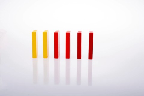 Colorful Domino Blocks in a line on a white background