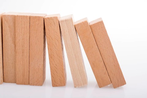 Wooden Domino Blocks in a line on a white background